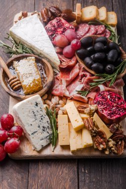 Geleneksel İtalyan antipasto tabağı. Tahta üzerinde çeşitli peynirler. 
