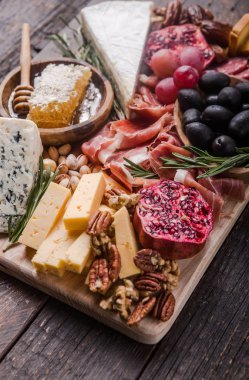 Geleneksel İtalyan antipasto tabağı. Tahta üzerinde çeşitli peynirler. 