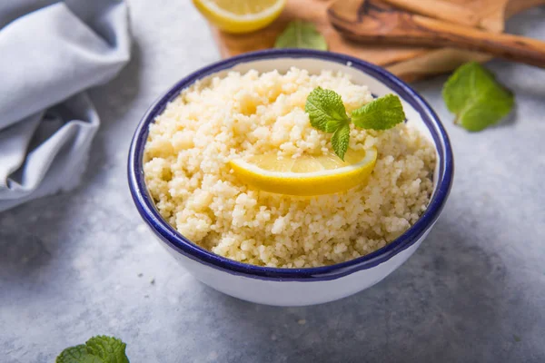 Couscous with mint and lemon in plate on dark rustic table from — 스톡 사진