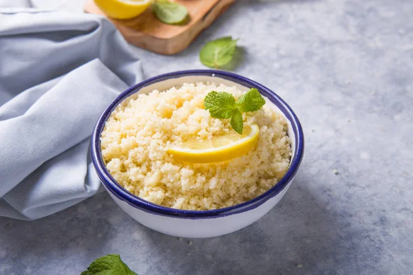 Couscous with mint and lemon in plate on dark rustic table from — 스톡 사진