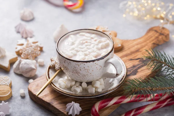 Hot chocolate cacao drinks with marshmallows in Christmas white mug on grey background. Traditional hot beverage, festive cocktail at X-mas or New Year