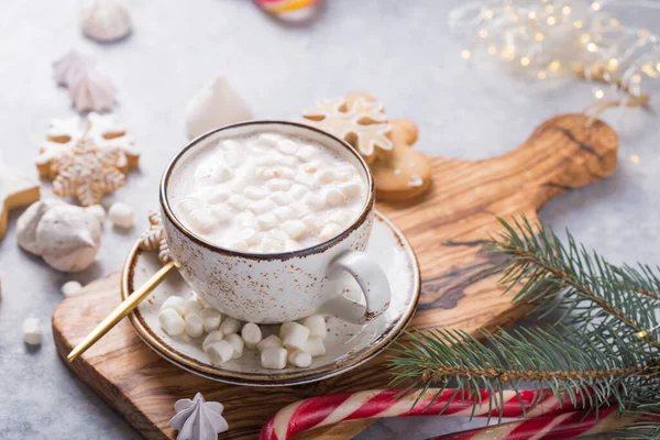Hot chocolate cacao drinks with marshmallows in Christmas color mug on grey background. Traditional hot beverage, festive cocktail at X-mas or New Year
