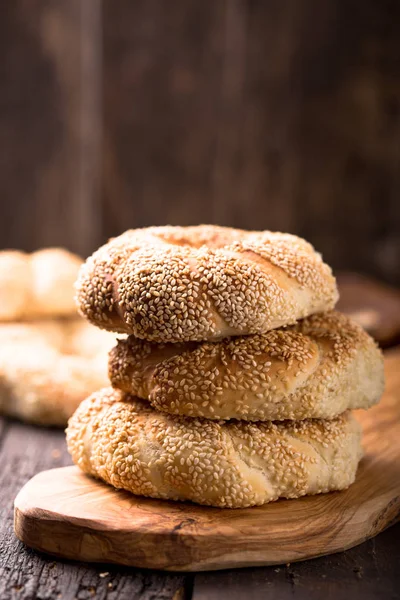 Greek koulouri or Turkish bagels called Simit in stack. Traditional street food, crispy sesame bread ring bagels