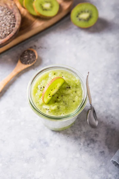 Healthy vegan chia pudding in a glass with fresh kiwi. Organic food concept