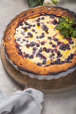 Clafoutis - geleneksel Fransız böğürtlenli turta, kırsal ahşap masada tatlı..