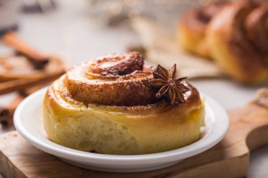 Şekerleme fırını. Beton arka planda tarçınlı tatlı, yumuşak rulo çörek. Noel yemeği tarifi