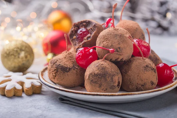 Christmas Sweet candies on the dessert table . Balls of biscuit with cherry - loli pop or cake pop. New year decoration and apple cider drink. happy holidey concept