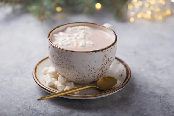 Hot chocolate cacao drinks with marshmallows in Christmas mugs on grey background. Traditional hot beverage, festive cocktail at X-mas or New Year