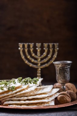 Hamursuz Bayramı, mayasız ekmek ziyafeti, matzah ekmeği ve parlak metal tepside kırmızı şarap kadehleri..