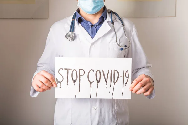 Doctor holding stop sign  Stop COVID-19 conceptual image.