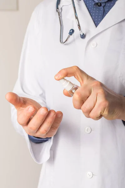 Doctor hands using washing hand with Alcohol Sanitizer  on a white background. Protect themselves from virus infection in Corona virus crisis 2020