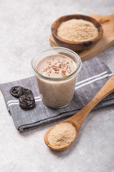 Vegan non dairy drink, with oat bran on white concrete background. Healthy eating