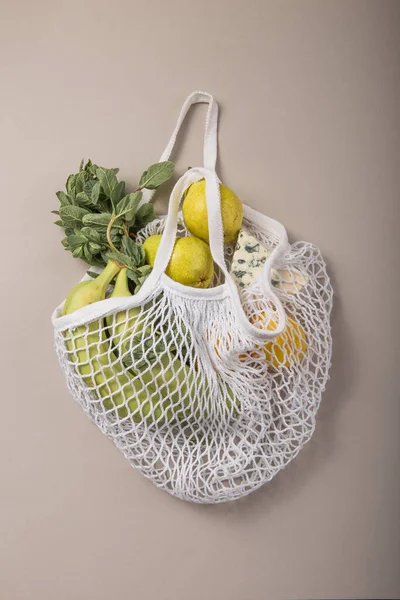 Zero waste concept. Colorful lifestyle. No Plastic free items. Reuse, reduce, refuse. Package-free food shopping. Eco friendly natural bag with organic fruits and vegetables. Top view.