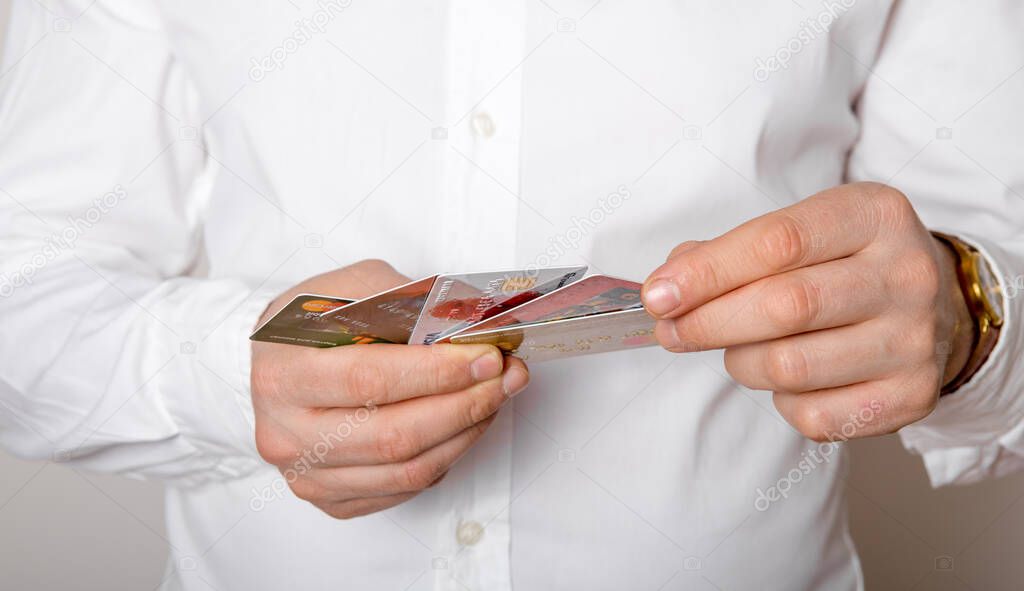 Man hands over credit cards for payment. Shallow DOF