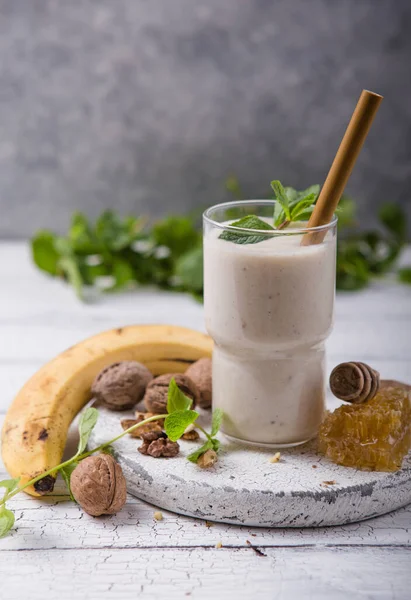 Healthy breakfast. Banana walnuts smoothie with collagen, coconut milk in glass jar