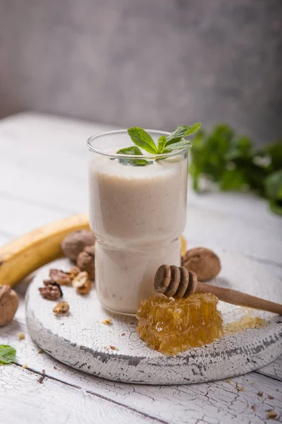 Healthy breakfast. Banana walnuts smoothie with collagen, coconut milk in glass jar