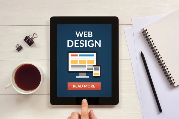 Web design concept on tablet screen with office objects