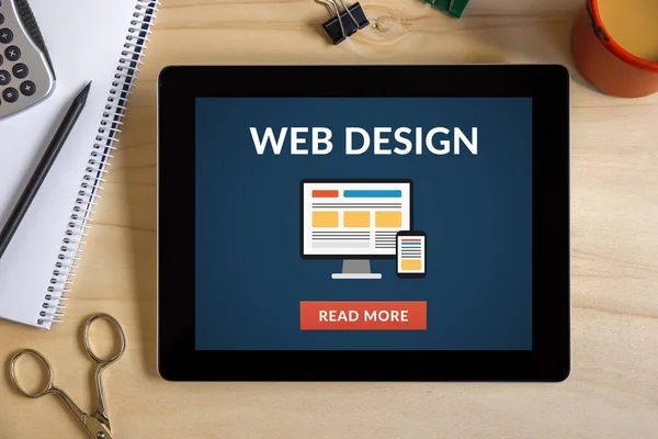 Web design concept on tablet screen with office objects