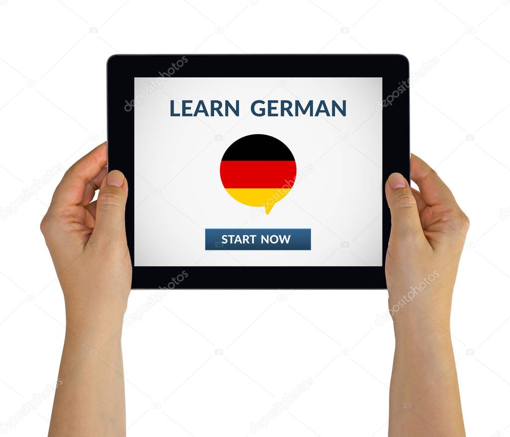 Hands holding tablet with learn german concept on screen
