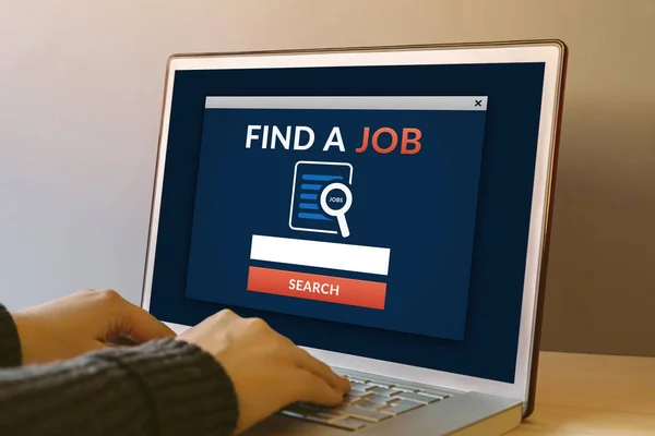 Find a job concept on laptop computer screen on wooden table