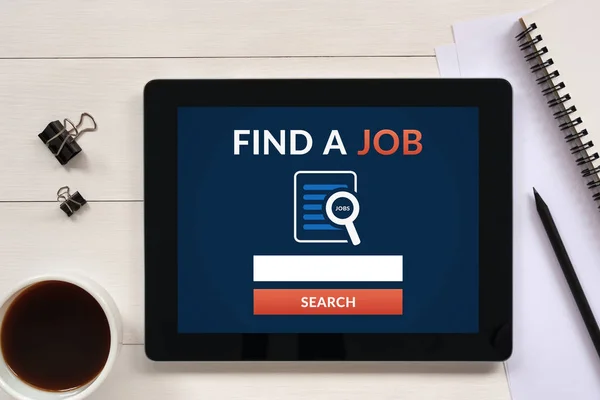 Find a job concept on tablet screen with office objects