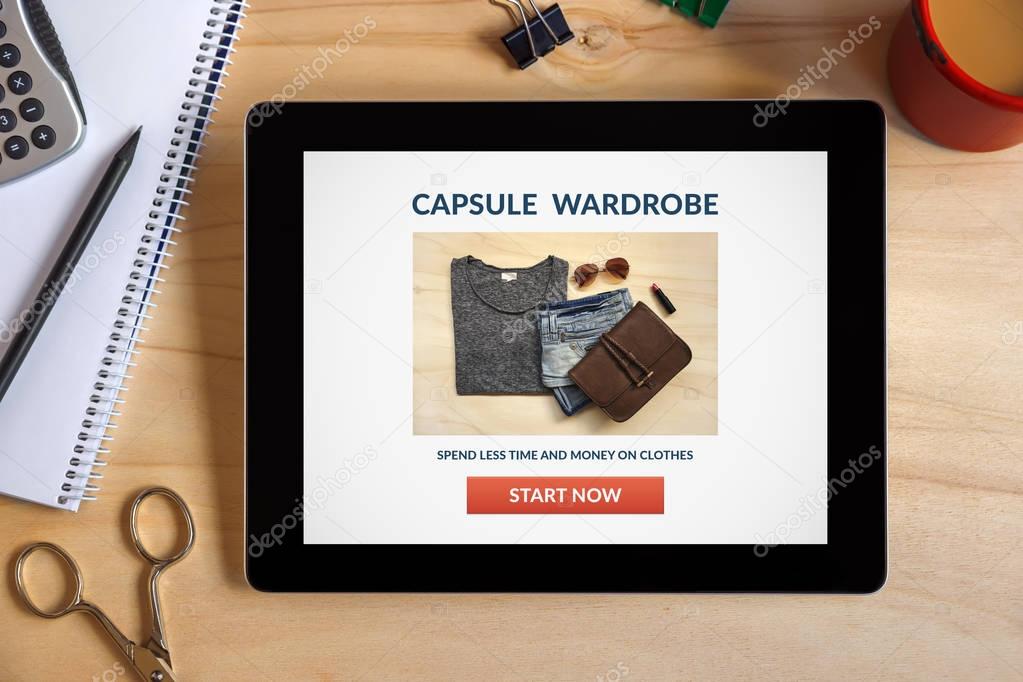 Capsule wardrobe concept on tablet screen with office objects