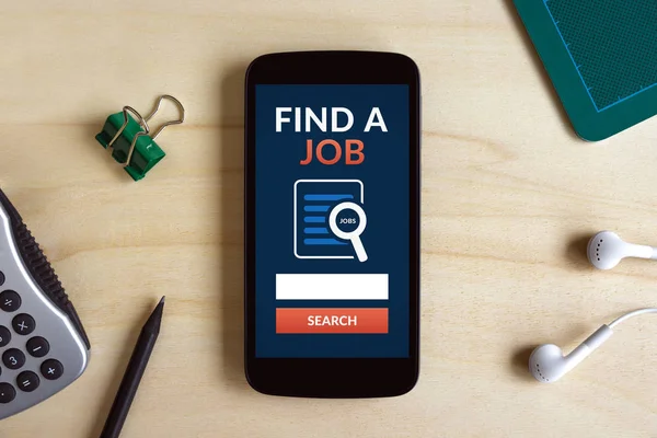 Find a job concept on smart phone screen on wooden desk