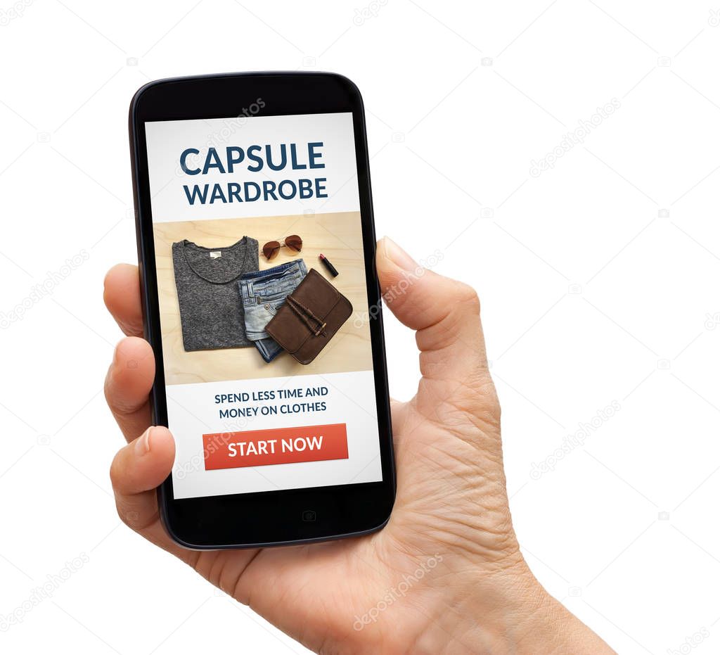 Hand holding smart phone with capsule wardrobe concept on screen