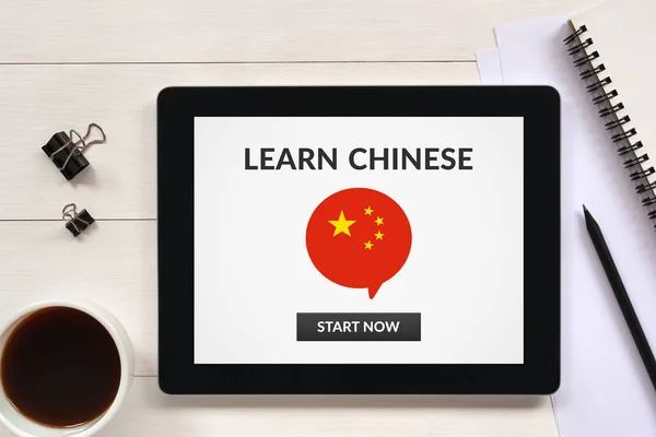 Learn Chinese concept on tablet screen with office objects