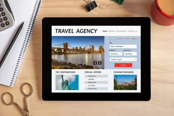 Travel agency concept on tablet screen with office objects