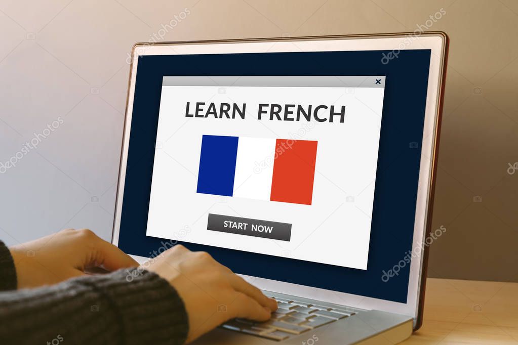 Learn French concept on laptop computer screen on wooden table