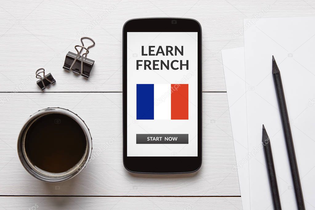 Learn French concept on smart phone screen with office objects