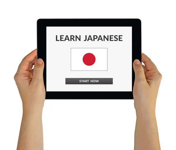 Mani che tengono tablet con imparare il concetto giapponese sullo schermo — Foto Stock