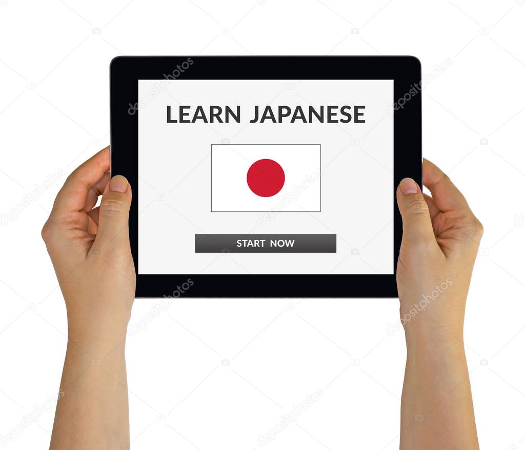 Hands holding tablet with learn Japanese concept on screen
