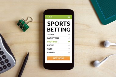Ahşap masa üzerinde akıllı telefon ekranında kavramı bahis spor