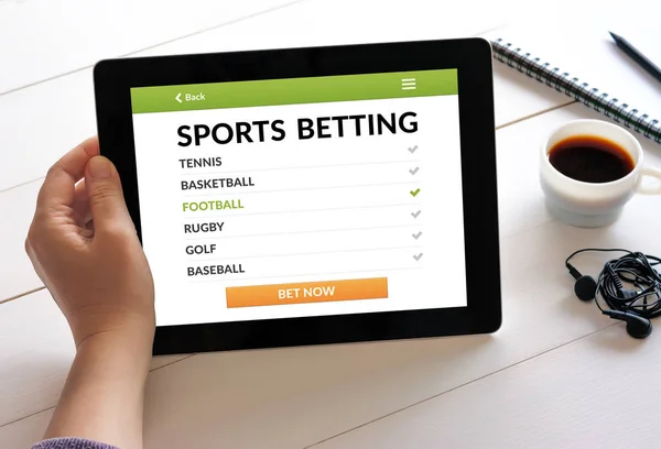 Hand holding tablet with sports betting concept on screen — Stock Photo, Image