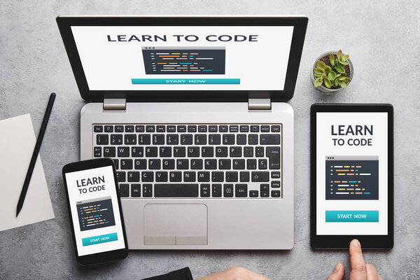 Learn to code concept on laptop, tablet and smartphone screen