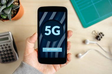 Ekranda 5G ağ konsepti olan akıllı bir telefon. Üst görünüm