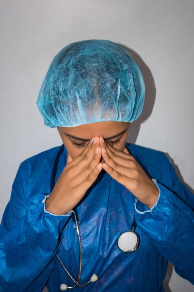 Concerned nurse with hands on face