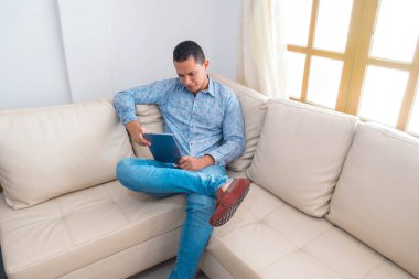 Gündüz vakti dijital tablet kullanan sıradan bir genç adam. Merkez ofis kavramı