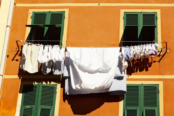 drying clothes at the window in a cinque terre village