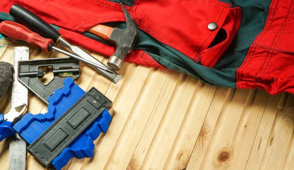 Tools and working clothes on the table — Stock Photo, Image