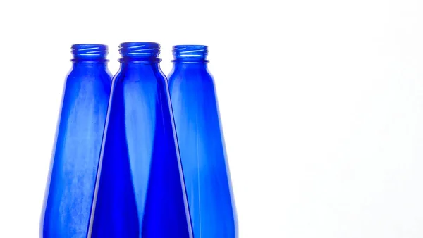 Blå flaskor över vita — Stockfoto