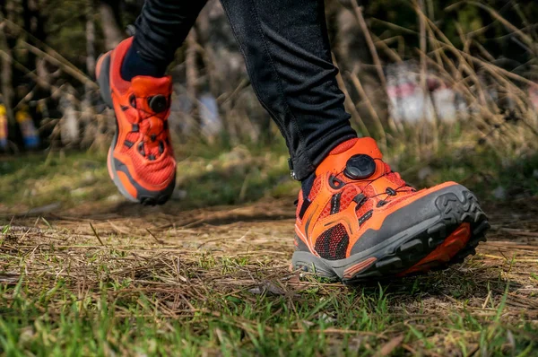 Sporty woman running in forest in early spring. Fitness and workout wellness concept