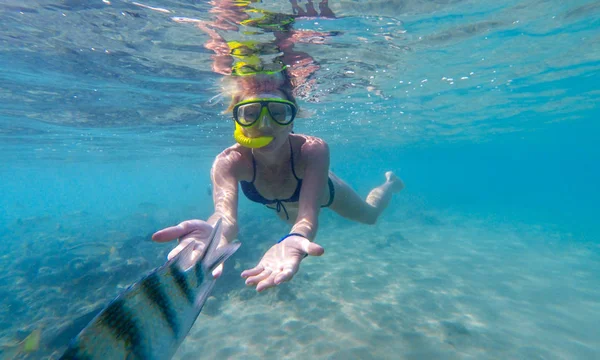 Mujer nadando bajo el agua con peces de colores — Foto de Stock