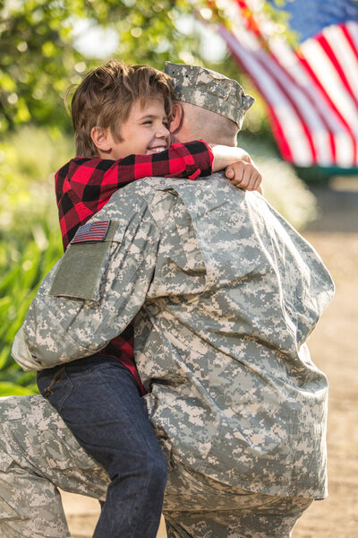 American soldier reunited with son on a sunny day 