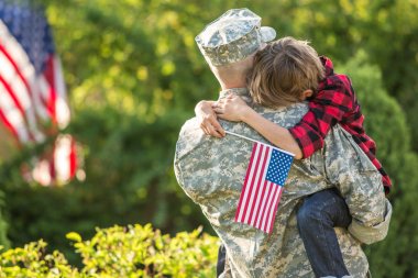American soldier reunited with son on a sunny day  clipart