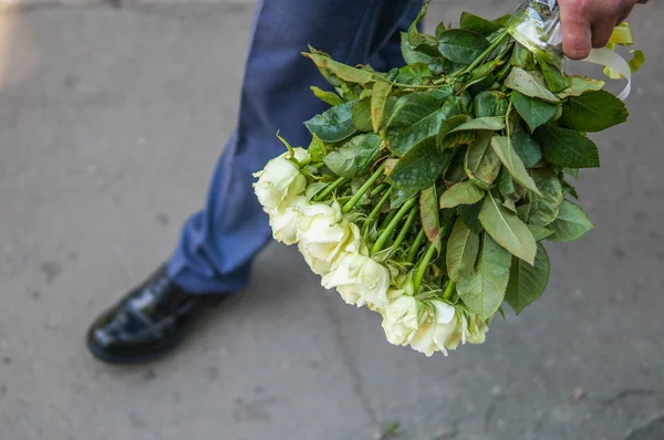 Bridegroom holds flowers