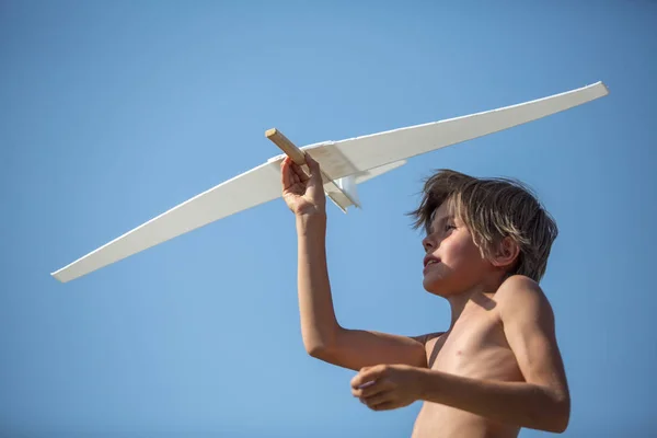 Boy with plane over blue sky — Stock Photo, Image
