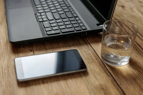 Werkproces - afbeelding van de smartphone, glas water, overlappingsbovenkant. selectieve aandacht op glas water — Stockfoto